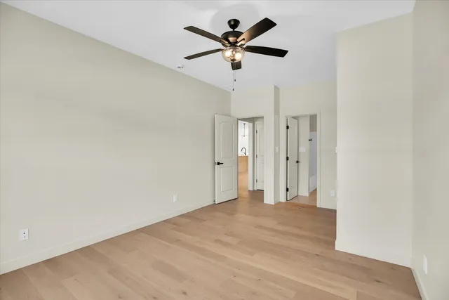 a bathroom with a granite countertop sink a toilet and a mirror