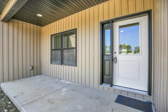 a view of a hallway with wooden floor and closet