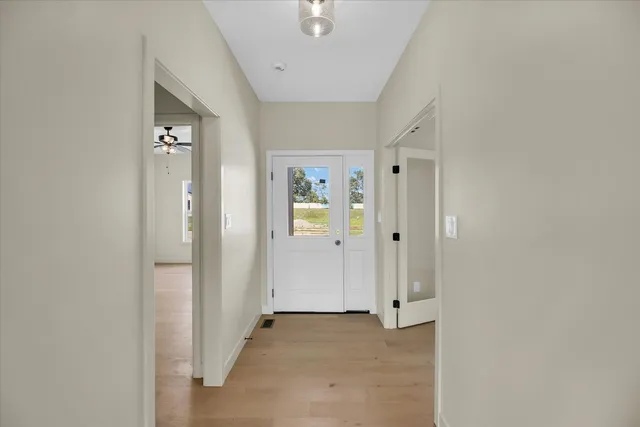an empty room with windows and fireplace