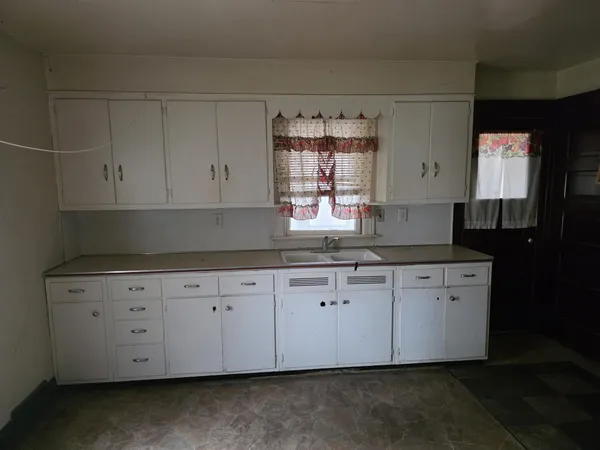 a view of a refrigerator and a stove