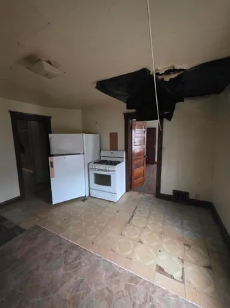 a view of empty room with window and fireplace