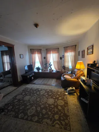 a living room with furniture flowerpot and window