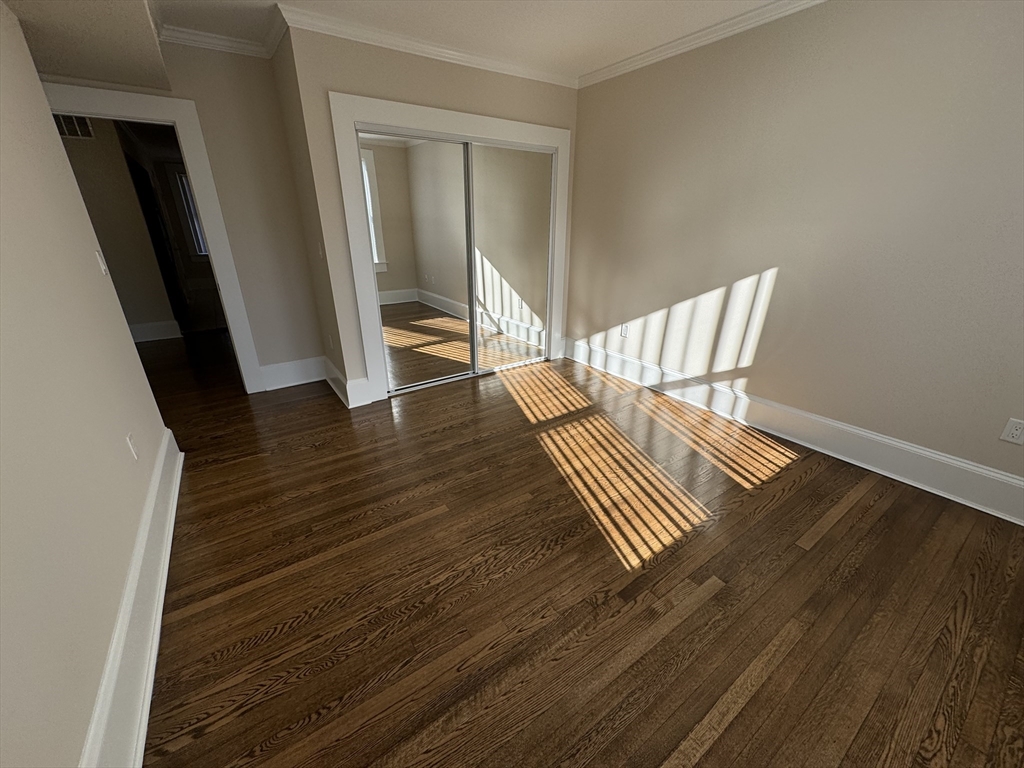 18 Short Street, Unit 3 Brookline, MA 02446 - Photo 12 of 14 a view of wooden floor and windows in a room
