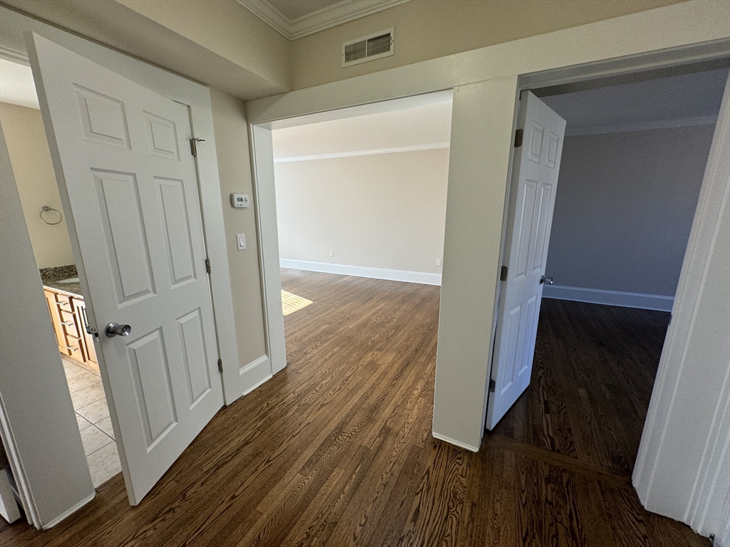 18 Short Street, Unit 3 Brookline, MA 02446 - Photo 5 of 14 wooden floor with a mirror