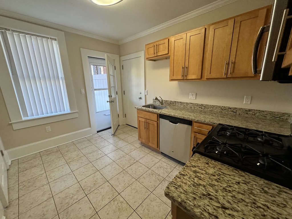 18 Short Street, Unit 3 Brookline, MA 02446 - Photo 7 of 14 a kitchen with a sink a stove and cabinets