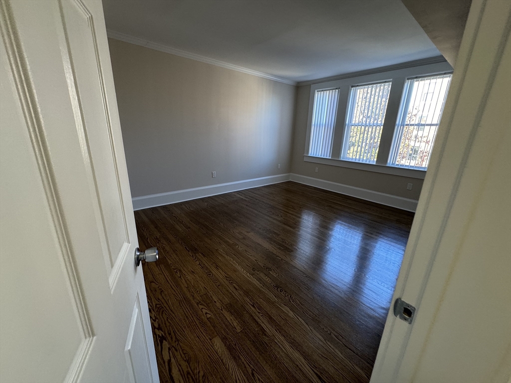 18 Short Street, Unit 3 Brookline, MA 02446 - Photo 9 of 14 a view of an empty room and wooden floor