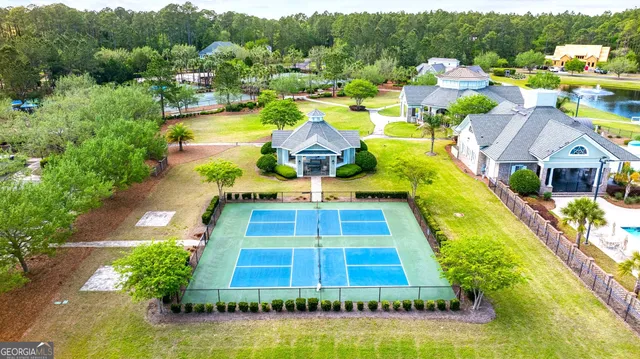 a aerial view of a house with swimming pool and a garden