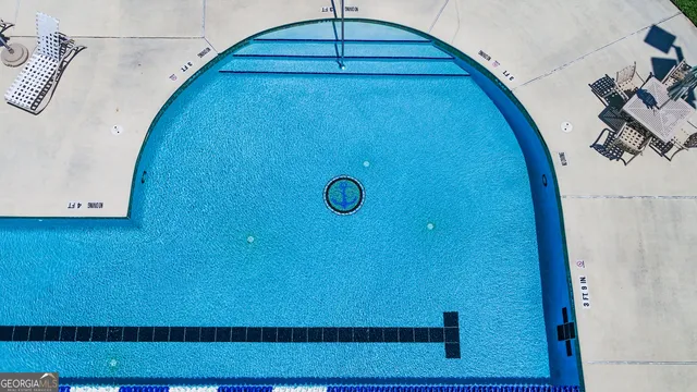 an aerial view of a house with swimming pool garden and patio