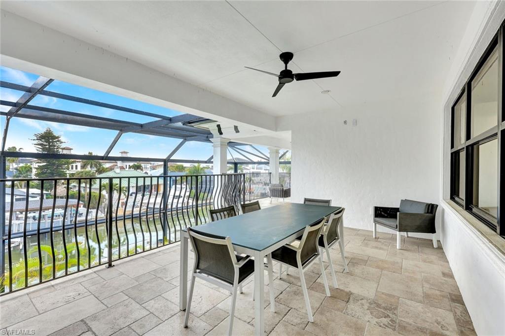 494 Seagull Avenue Naples, FL 34108 - Photo 11 of 32 a dining room with furniture and a floor to ceiling window