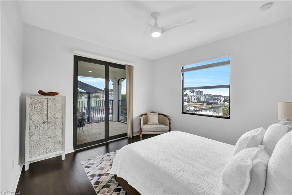 494 Seagull Avenue Naples, FL 34108 - Photo 17 of 32 a bedroom with a bed and a painting on the wall