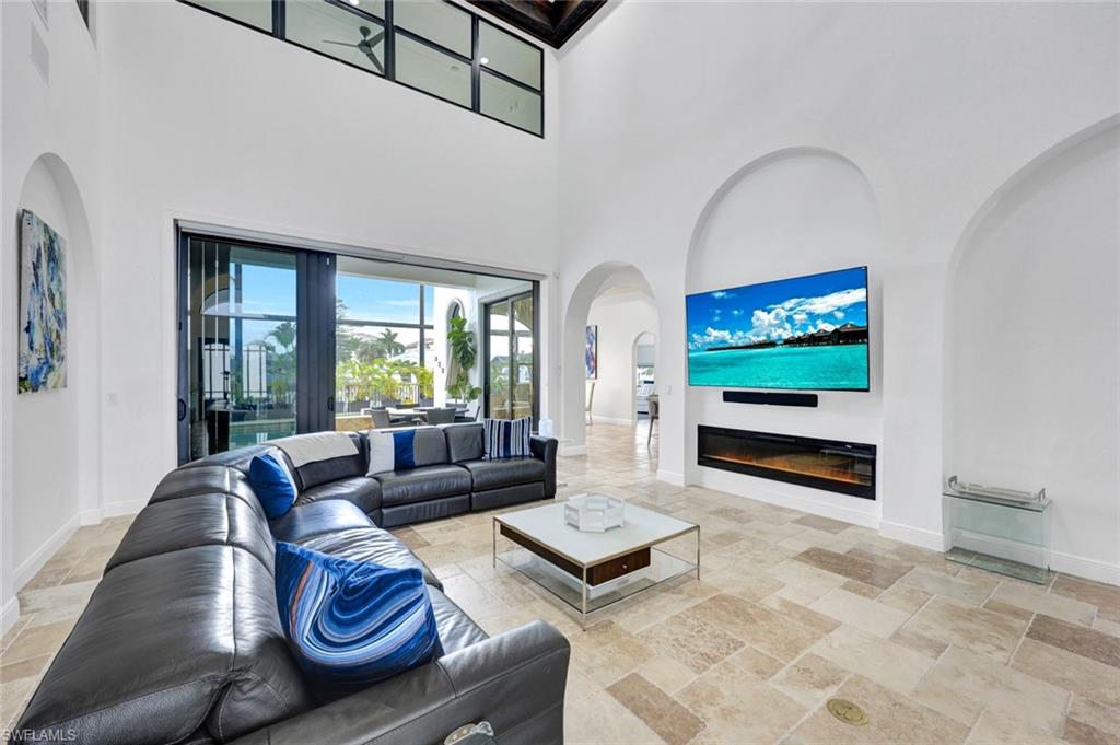 494 Seagull Avenue Naples, FL 34108 - Photo 2 of 32 a living room with furniture and a flat screen tv