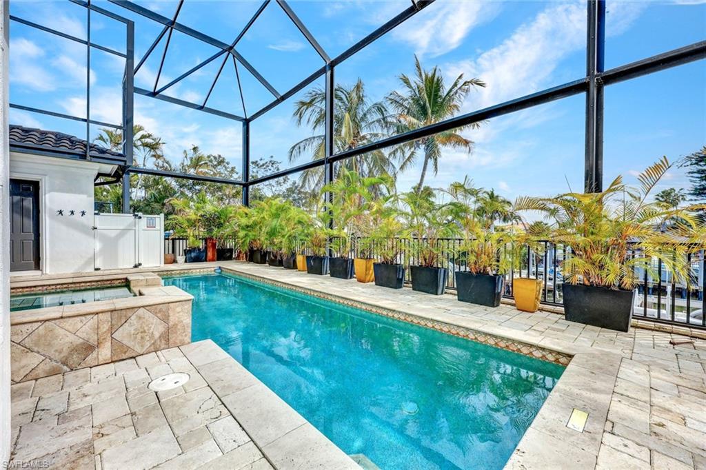 494 Seagull Avenue Naples, FL 34108 - Photo 23 of 32 a view of a swimming pool with a yard