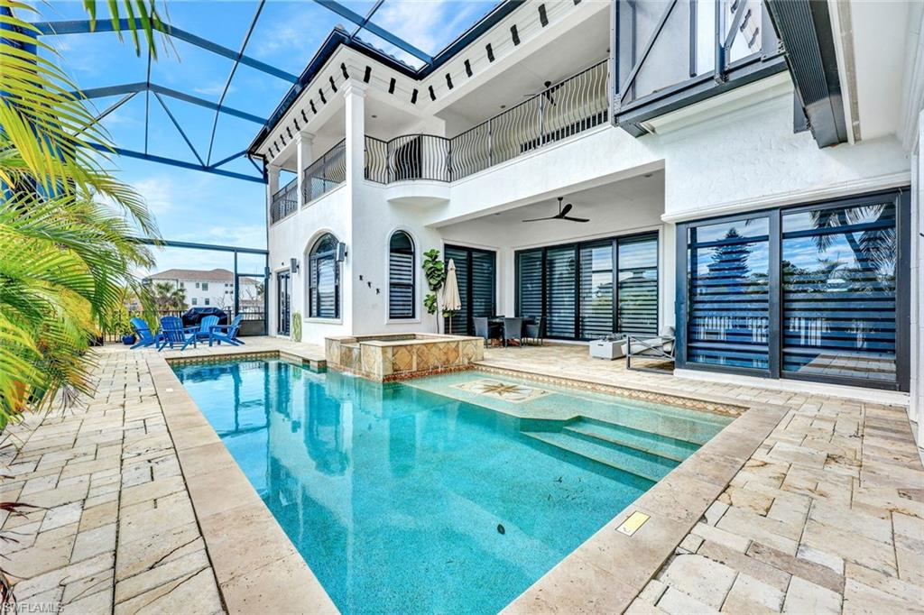 494 Seagull Avenue Naples, FL 34108 - Photo 25 of 32 a view of swimming pool with outdoor seating
