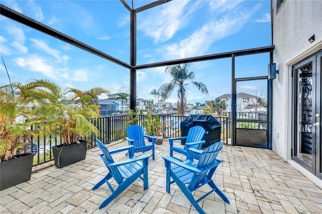 494 Seagull Avenue Naples, FL 34108 - Photo 26 of 32 a view of a chairs and table in patio