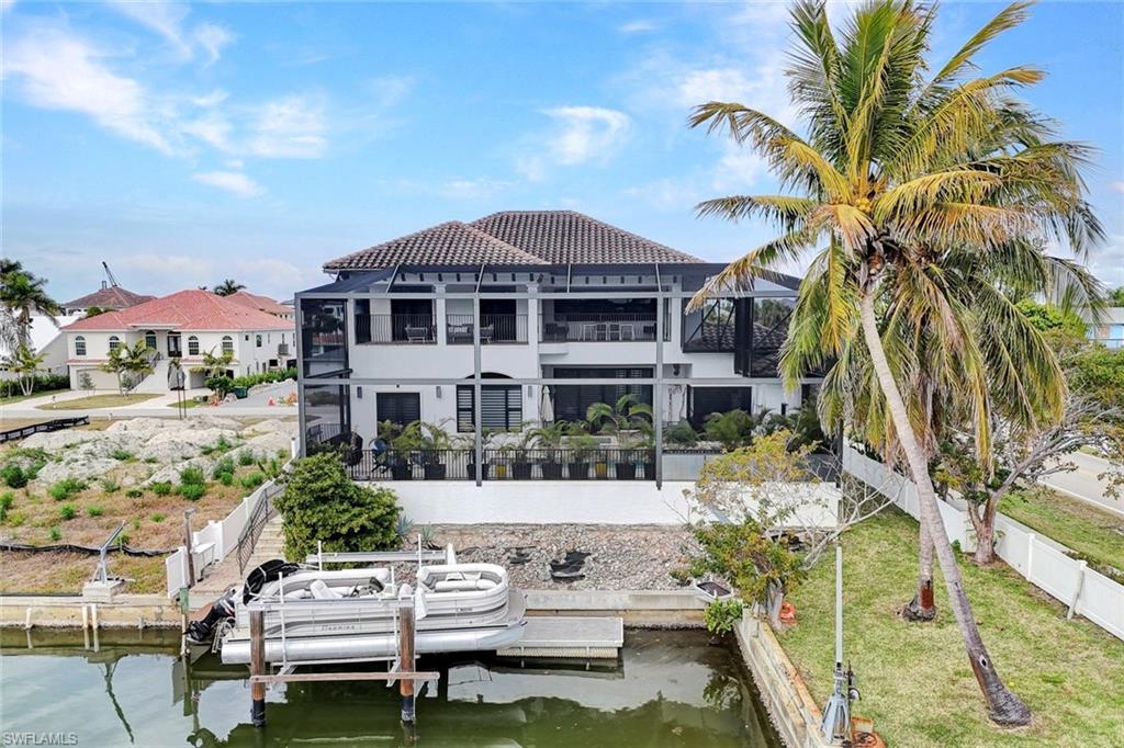 494 Seagull Avenue Naples, FL 34108 - Photo 27 of 32 a front view of a house with a yard