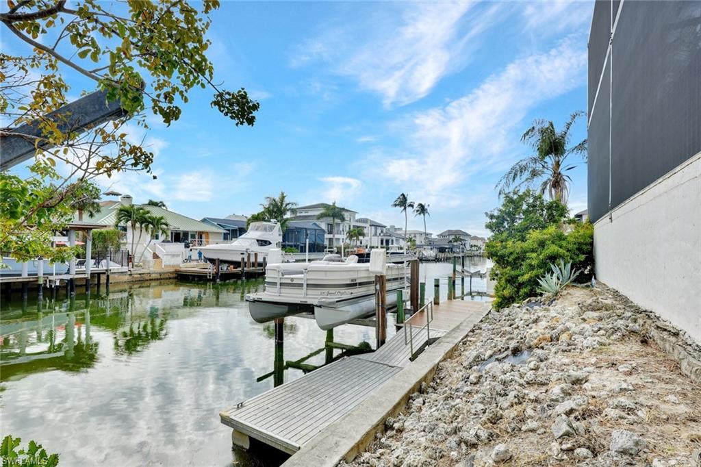 494 Seagull Avenue Naples, FL 34108 - Photo 28 of 32 a view of a lake with houses