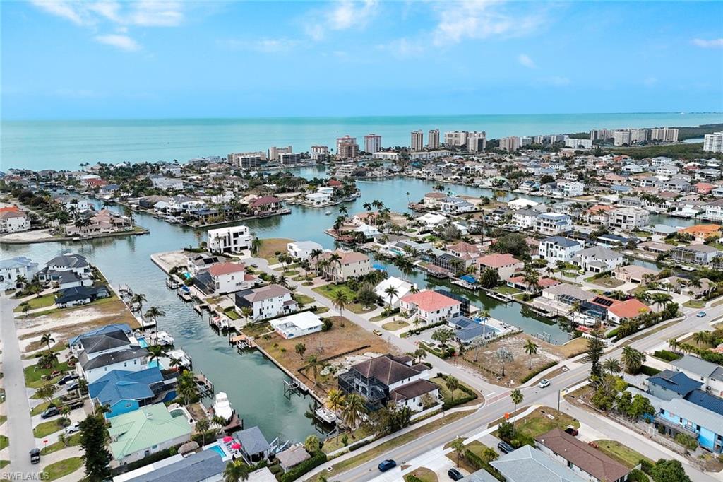 494 Seagull Avenue Naples, FL 34108 - Photo 29 of 32 an aerial view of a city with lots of residential buildings and ocean view in back