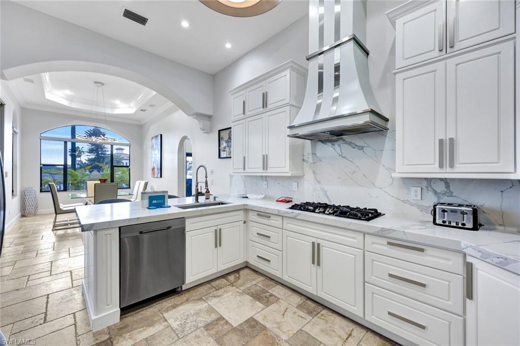 494 Seagull Avenue Naples, FL 34108 - Photo 5 of 32 a kitchen with stainless steel appliances granite countertop a sink and cabinets