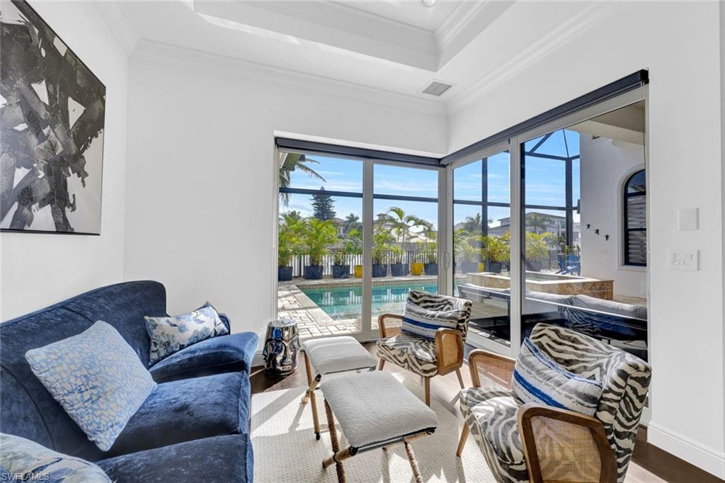 494 Seagull Avenue Naples, FL 34108 - Photo 8 of 32 a living room with furniture and a large window