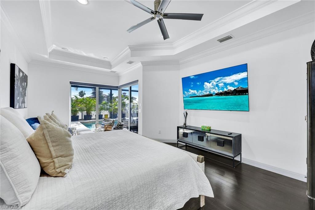 494 Seagull Avenue Naples, FL 34108 - Photo 9 of 32 a bedroom with a bed and a flat screen tv