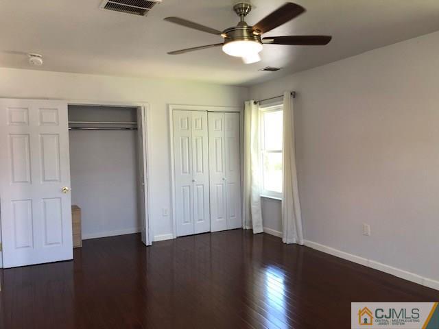 7 Gurley Road Edison, NJ 08817 - Photo 21 of 25 a view of an empty room with wooden floor and a window