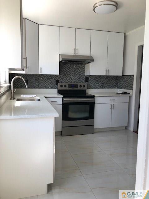 7 Gurley Road Edison, NJ 08817 - Photo 5 of 25 a kitchen with granite countertop a sink stainless steel appliances and cabinets