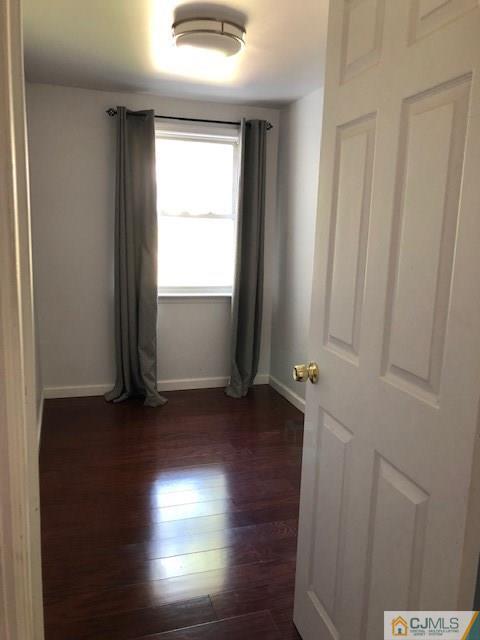 7 Gurley Road Edison, NJ 08817 - Photo 8 of 25 an empty room with wooden floor and windows