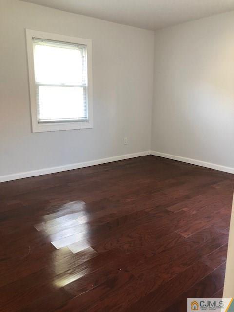 7 Gurley Road Edison, NJ 08817 - Photo 9 of 25 a view of an empty room with wooden floor and a window