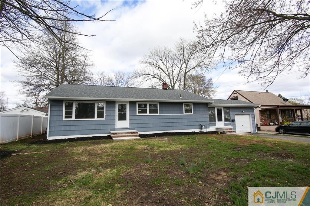 102 Magnolia Road Iselin, NJ 08830 - Photo 1 of 36 a front view of a house with a garden and trees
