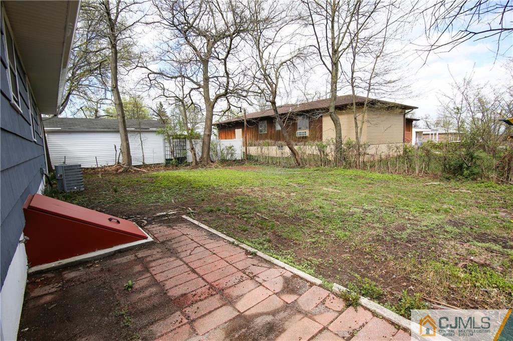 102 Magnolia Road Iselin, NJ 08830 - Photo 17 of 36 a backyard of a house with lots of green space