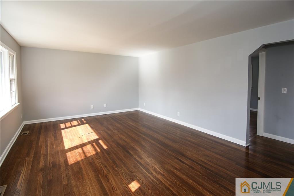 102 Magnolia Road Iselin, NJ 08830 - Photo 21 of 36 an empty room with wooden floor and windows