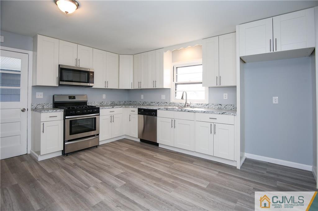 102 Magnolia Road Iselin, NJ 08830 - Photo 22 of 36 a kitchen with a white cabinets and window