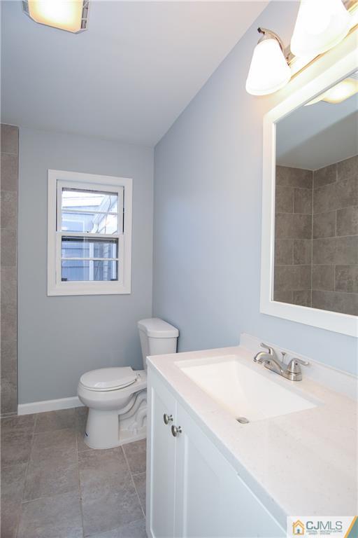 102 Magnolia Road Iselin, NJ 08830 - Photo 24 of 36 a bathroom with a sink toilet and a mirror