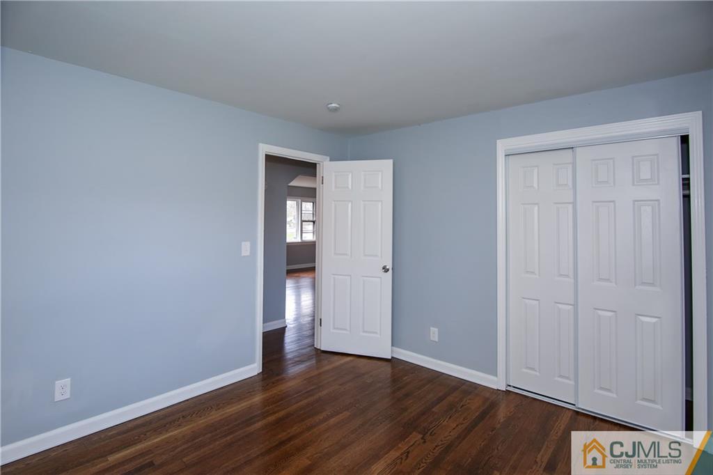 102 Magnolia Road Iselin, NJ 08830 - Photo 27 of 36 a view of an empty room with wooden floor