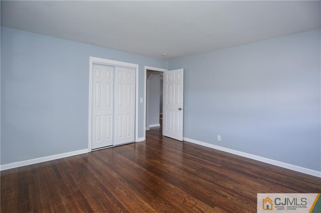 102 Magnolia Road Iselin, NJ 08830 - Photo 29 of 36 a view of an empty room with wooden floor