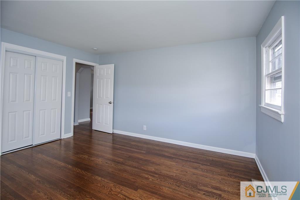 102 Magnolia Road Iselin, NJ 08830 - Photo 30 of 36 a view of an empty room with wooden floor and a window