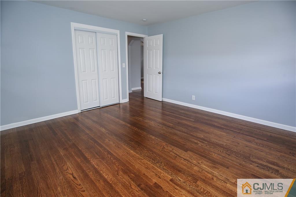 102 Magnolia Road Iselin, NJ 08830 - Photo 31 of 36 a view of an empty room with wooden floor