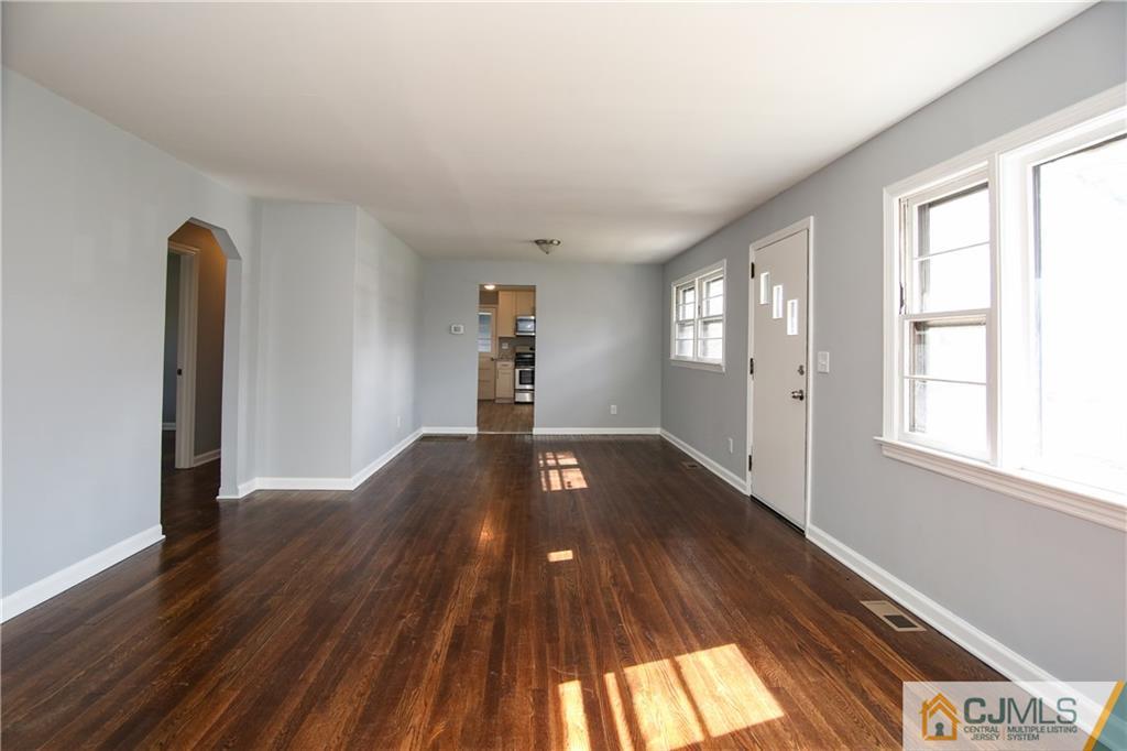 102 Magnolia Road Iselin, NJ 08830 - Photo 7 of 36 a view of empty room with wooden floor and fan