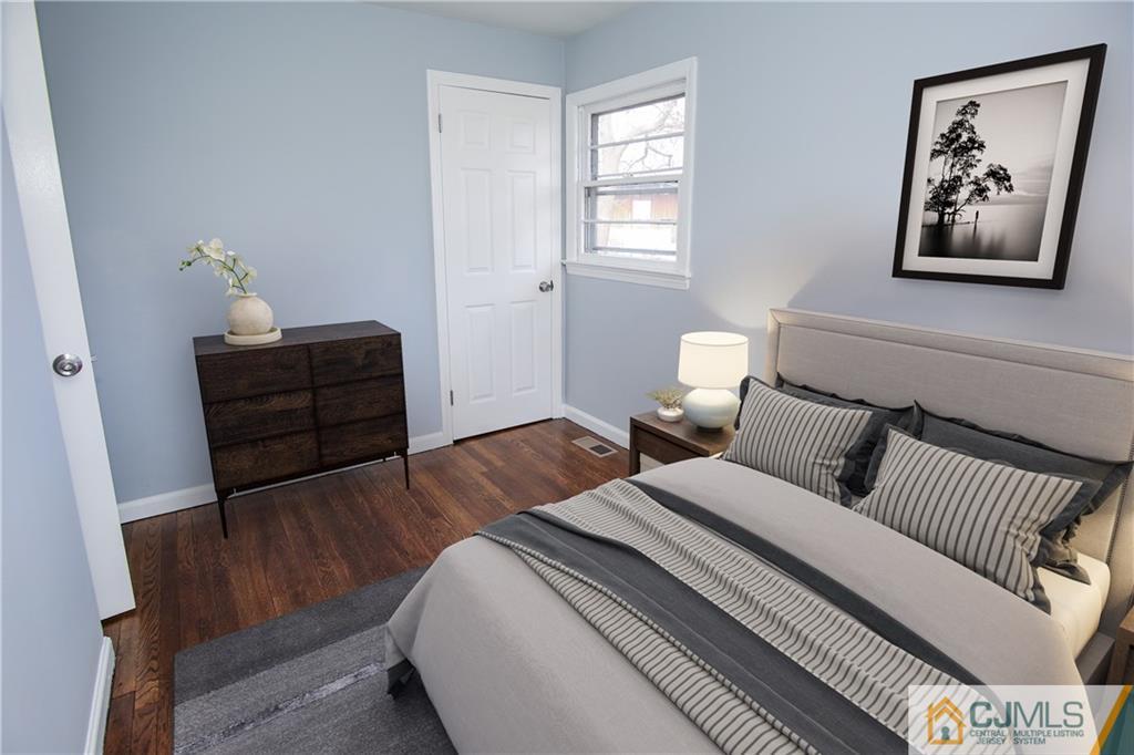 102 Magnolia Road Iselin, NJ 08830 - Photo 10 of 36 a bedroom with a bed and wooden floor