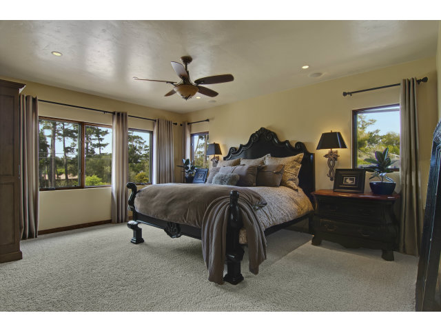 3027 Sherman Road Pebble Beach, CA 93953 - Photo 11 of 25 a spacious bedroom with a bed mirror and window
