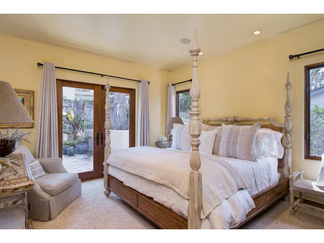 3027 Sherman Road Pebble Beach, CA 93953 - Photo 13 of 25 a bedroom with a large bed and a couch