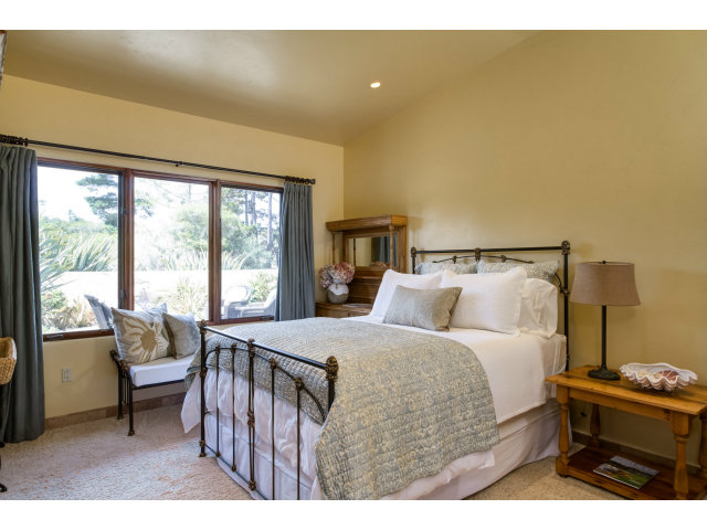 3027 Sherman Road Pebble Beach, CA 93953 - Photo 16 of 25 a bedroom with a bed and a night stand