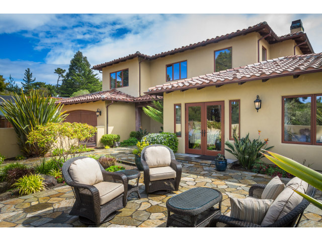 3027 Sherman Road Pebble Beach, CA 93953 - Photo 2 of 25 a view of a patio with couches table and chairs under an umbrella