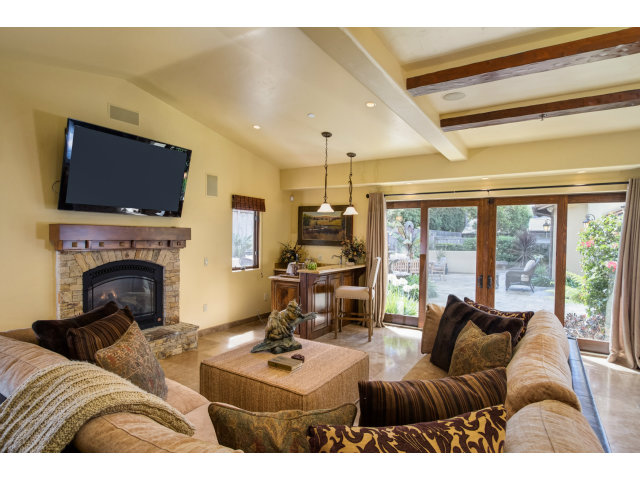 3027 Sherman Road Pebble Beach, CA 93953 - Photo 8 of 25 a living room with furniture a fireplace and a flat screen tv