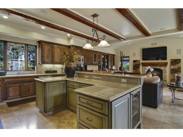 3027 Sherman Road Pebble Beach, CA 93953 - Photo 9 of 25 a kitchen with stainless steel appliances granite countertop a sink a stove and a wooden cabinets