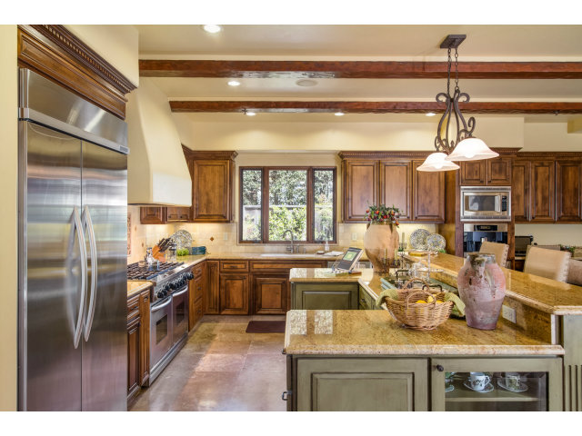 3027 Sherman Road Pebble Beach, CA 93953 - Photo 10 of 25 a kitchen with stainless steel appliances granite countertop a refrigerator and a stove