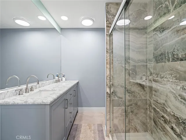 a bedroom with a bed and a refrigerator