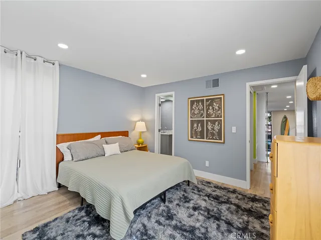 a bedroom with a bed and a lamp