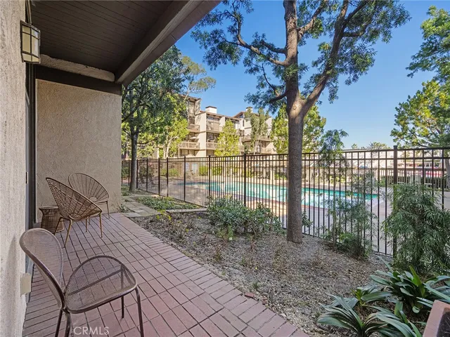 a view of a patio with a table and chairs and potted plants
