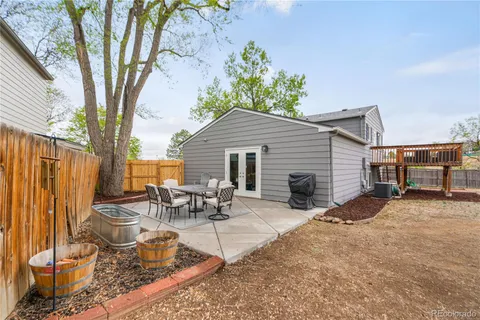 a backyard of a house with table and chairs